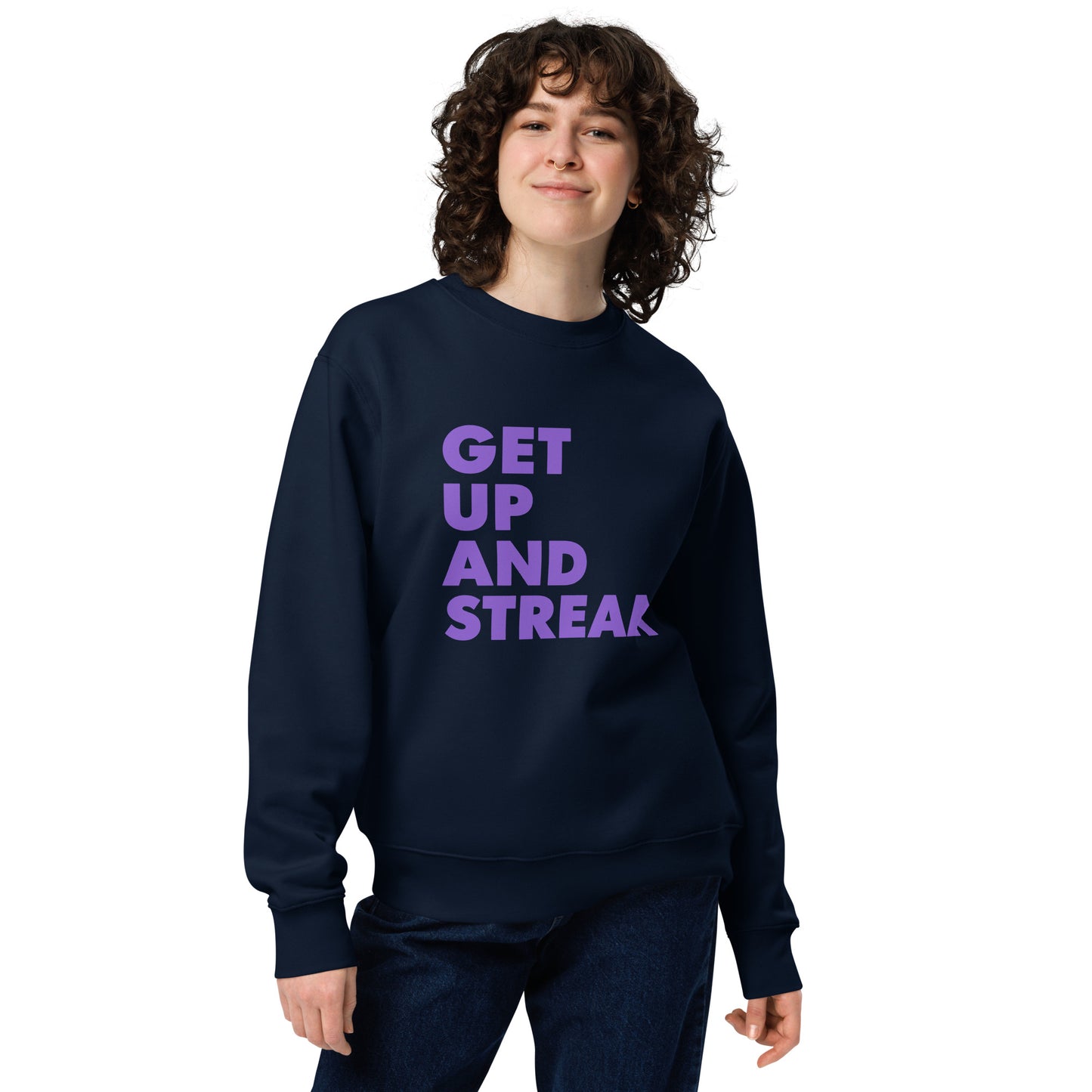 Product mockup navy. front view of female model wearing sweatshirt showing bold sans serif purple text, left justified, reading "Get up and stream"