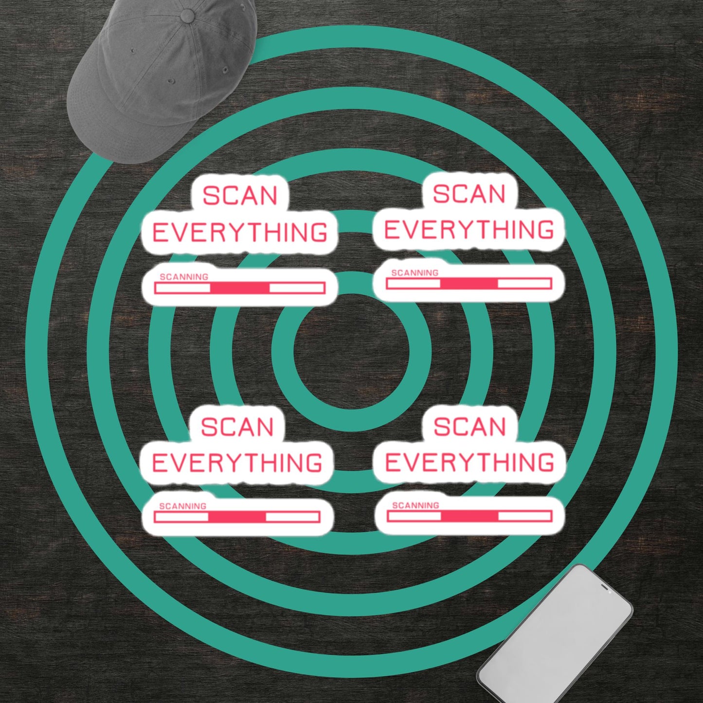 four sets of Scan Everything gamer merch vinyl stickers with pink text and graphics and a white border on a dark background with a grey baseball cap and a smart phone. mint green concentric circle graphic in background.