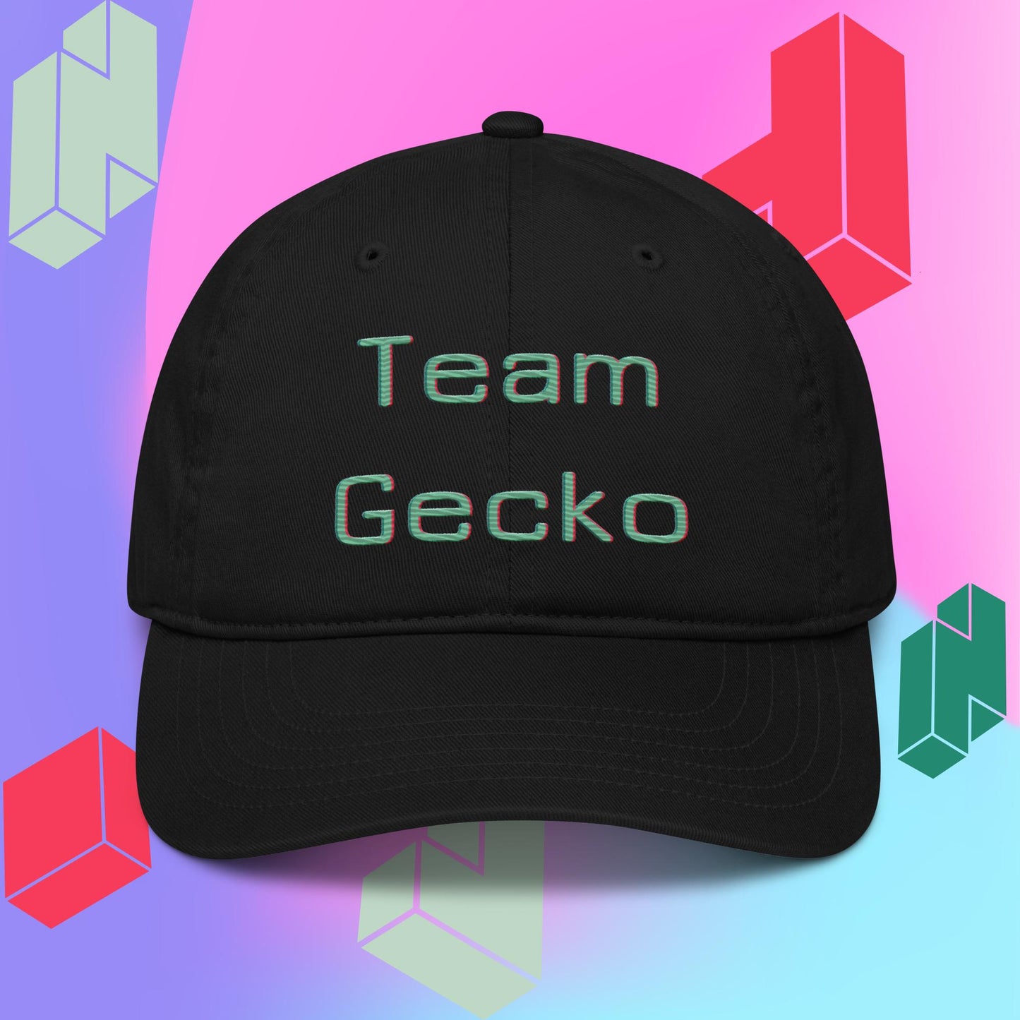 black organic cotton baseball cap with curved bill. Team Gecko glitch text embroidered on the front. Backdrop is purple pink and blue gradient with tetris style block graphics.
