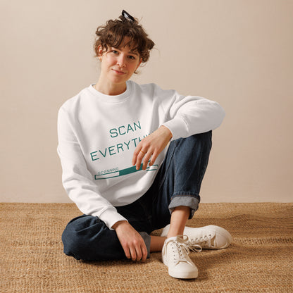 woman seated on hessian mat wearing white organic cotton gamer merch sweatshirt with mint green "Scan Everything " slogan and scanning progress bar graphic.